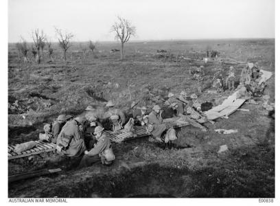 20th Bn. Resting on duckboards at the Railway Dugout near San Souci en route to Zonnebeke.10.1917. Photographer J.H. Hurley. Photograph source AWM E00838