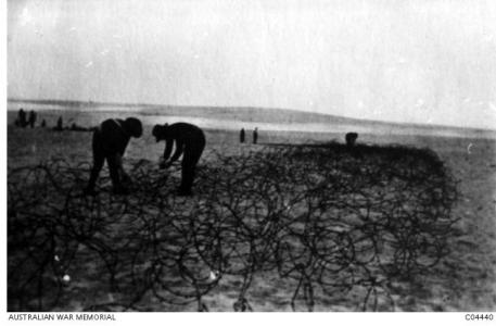 5th FCE putting down wire entanglements. Photographer unknown, photograph source AWM C04440