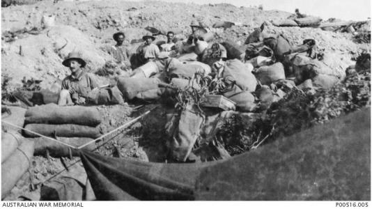 Australian 10th Light  Horse soldiers gather in the trenches after the charge of the Nek 1915. Photographer unknown, photograph source AWM P00516.005