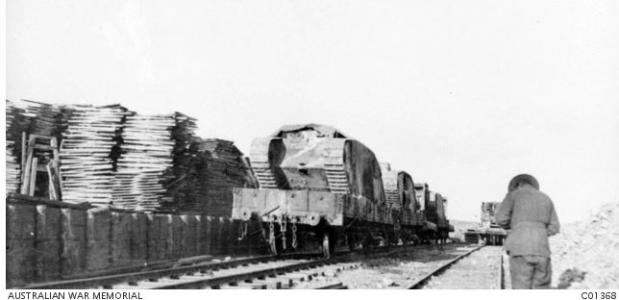 Damaged tanks from Pozieres loaded onto flat cars Australian Light Railway Corps. Photographer unknown, photograph source AWM C01368 