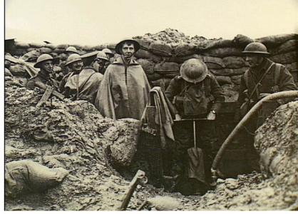 Ploegsteert, Belgium 1917. British Army soldiers pumping water from a trench.. Photograph donor British Offical Photograph No. D705. Photograph source AWM H09026