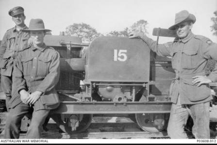 Unidentified soldiers from one ofthe  Australian Railway operating companies  next to a Simplex-narrow gauge tractor. Photograph source AWM P03608.012