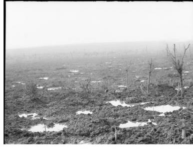 View across shell holes from Broodsiende Ridge, Passchendaele area, Ypres. Photograper unknown, photograph source AWM E01149